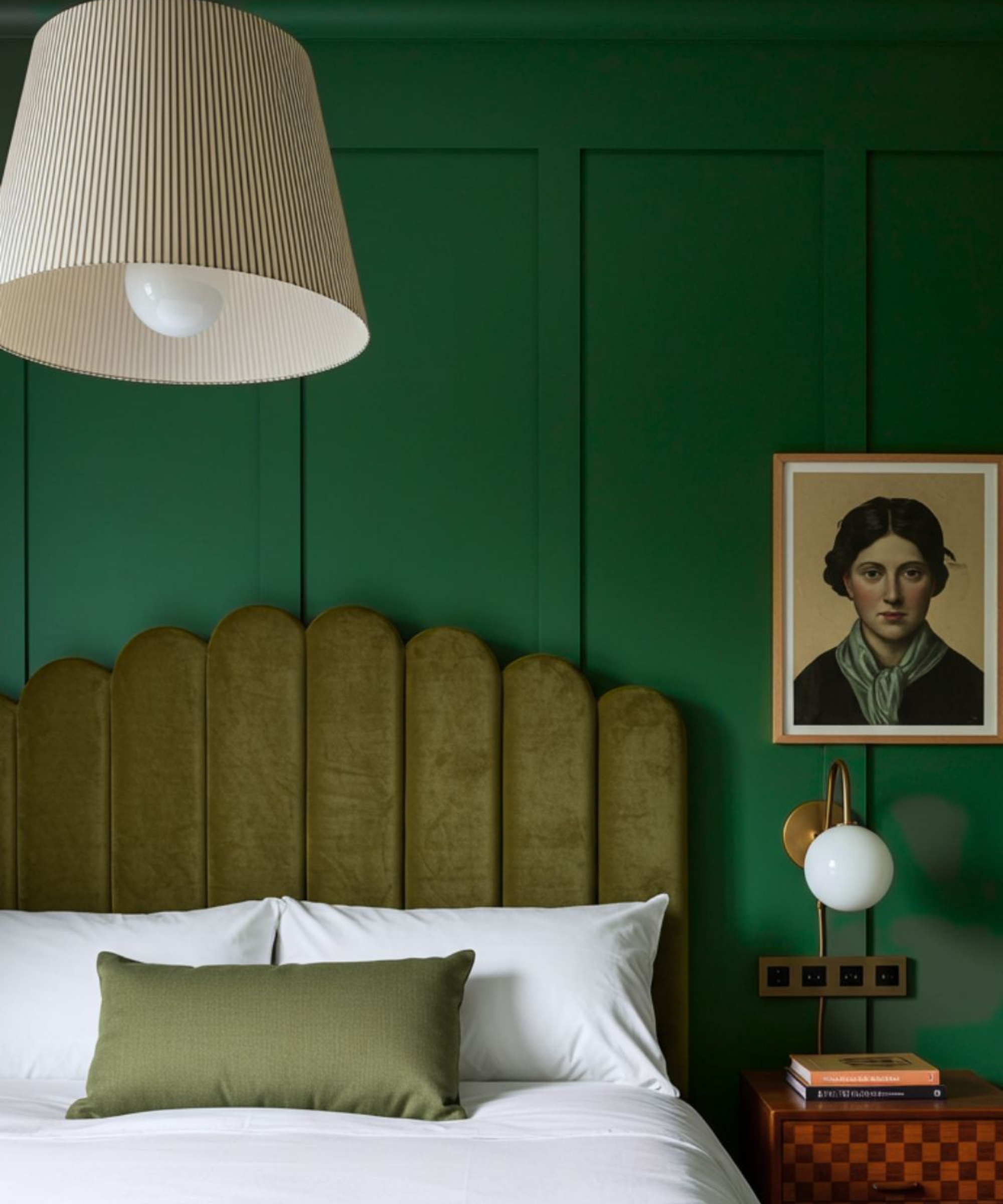 bedroom with vibrant bright green wall panelling, green headboard and cushion on bed