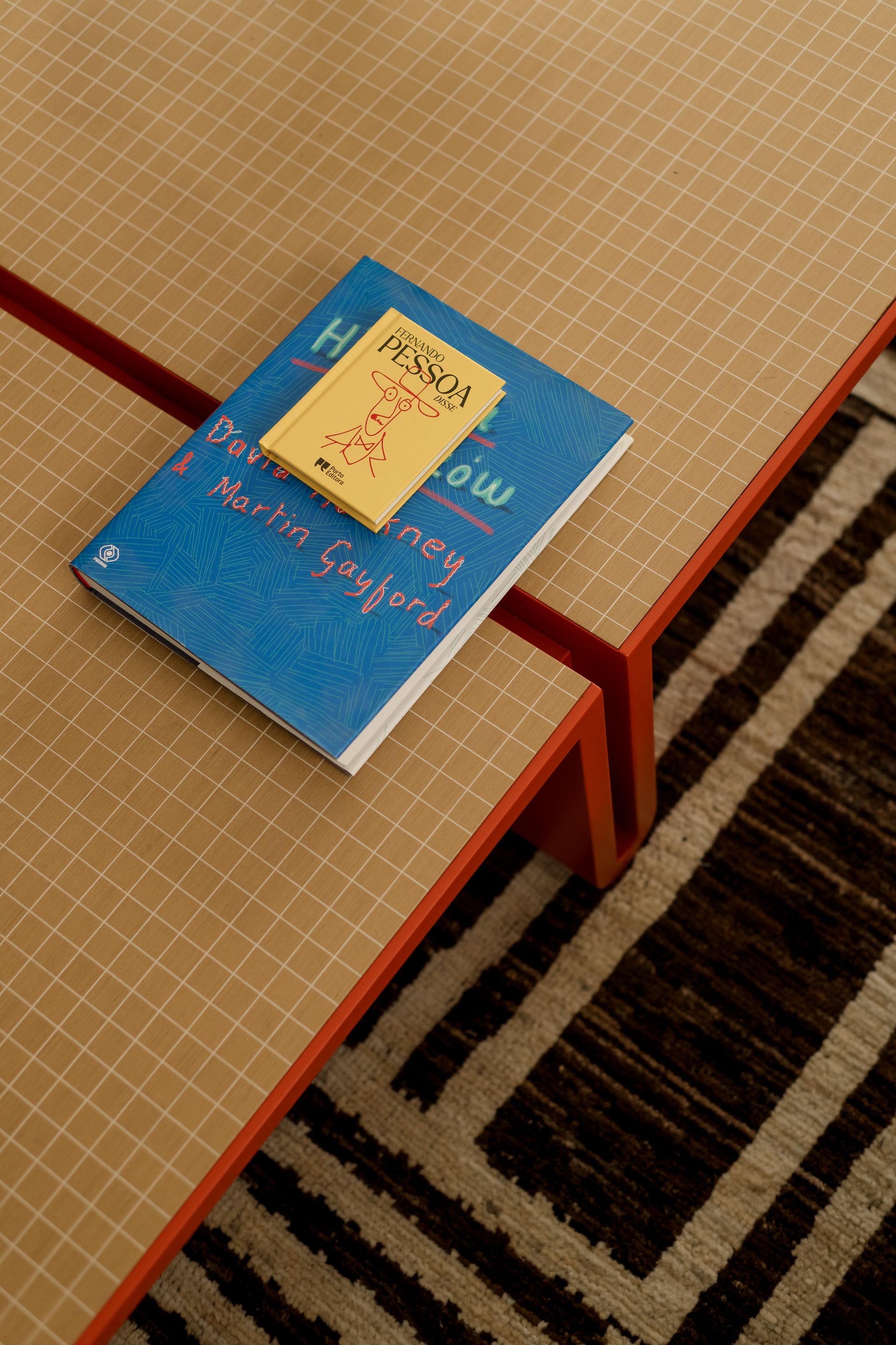 Books on a sand-colored coffee table