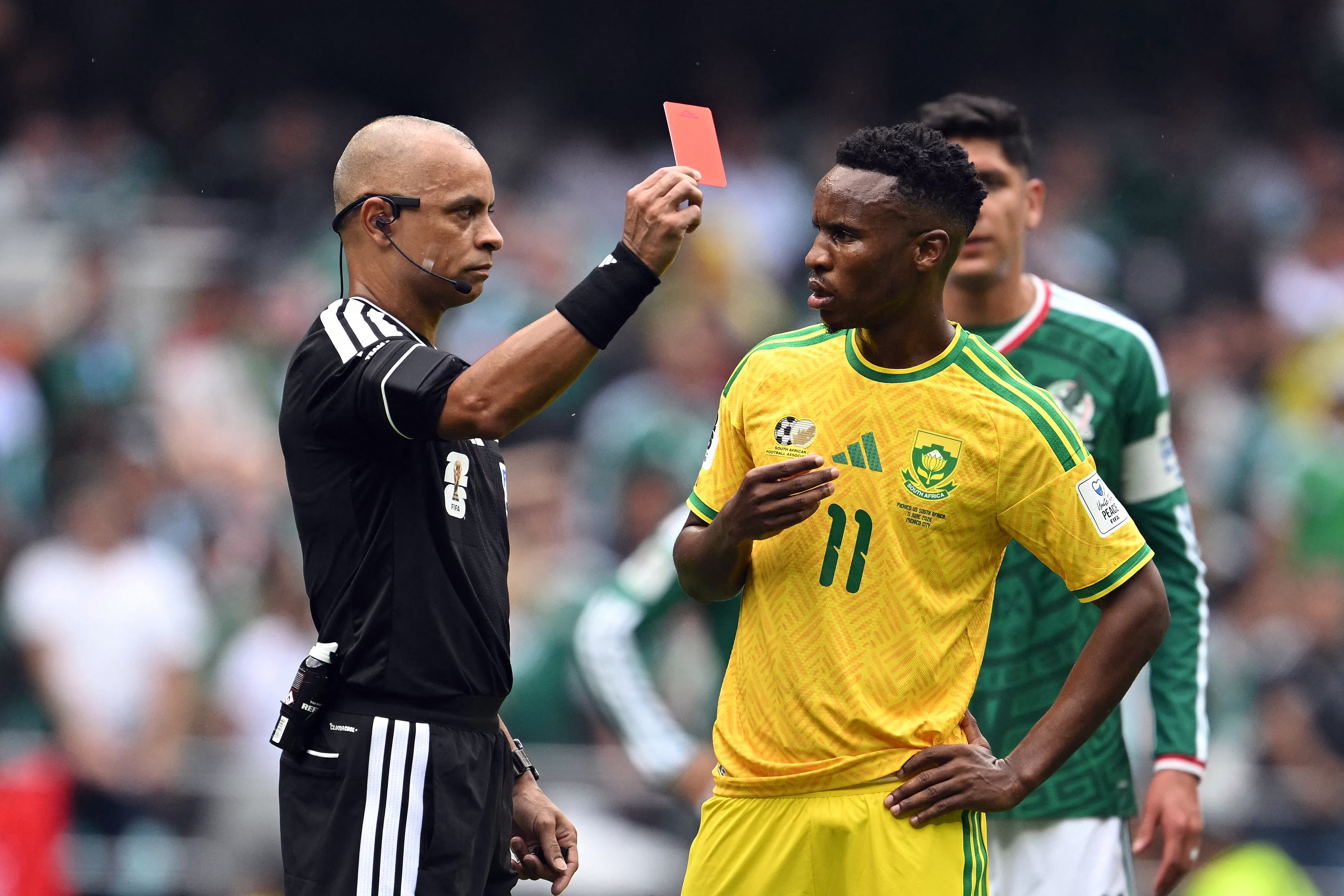Brazilian referee Wilton Sampaio shows a red card to South Africa's midfielder #11 Themba Zwane during the 2026 World Cup Group A football match between Mexico and South Africa at the Mexico City Stadium in Mexico City on June 11, 2026. (Photo by Yuri CORTEZ / AFP)