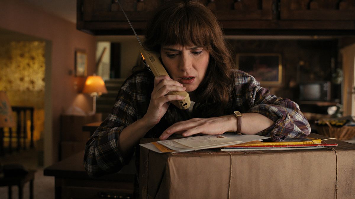 Joyce Byers talks on the phone to an unknown individual in Stranger Things season 4