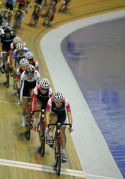 The men's points race is strung out single file.