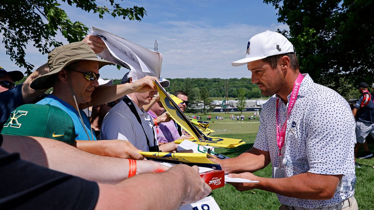 Bryson DeChambeau signs autographs for fans ahead of the 2024 PGA Championship