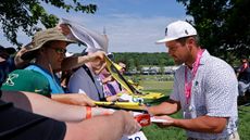 Bryson DeChambeau signs autographs for fans ahead of the 2024 PGA Championship