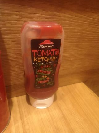 A ketchup bottle that reads "Tomato Ketchup, shake, squeeze and squirt"