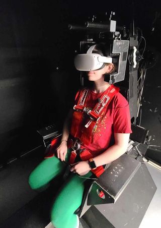a person in a vr headset sitting in a chair