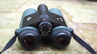 Swarovski Optik AX Visio binoculars on a stone floor