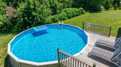 above ground pool with deck and sun loungers