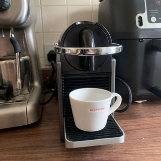 Nespresso coffee machine with espresso cup under