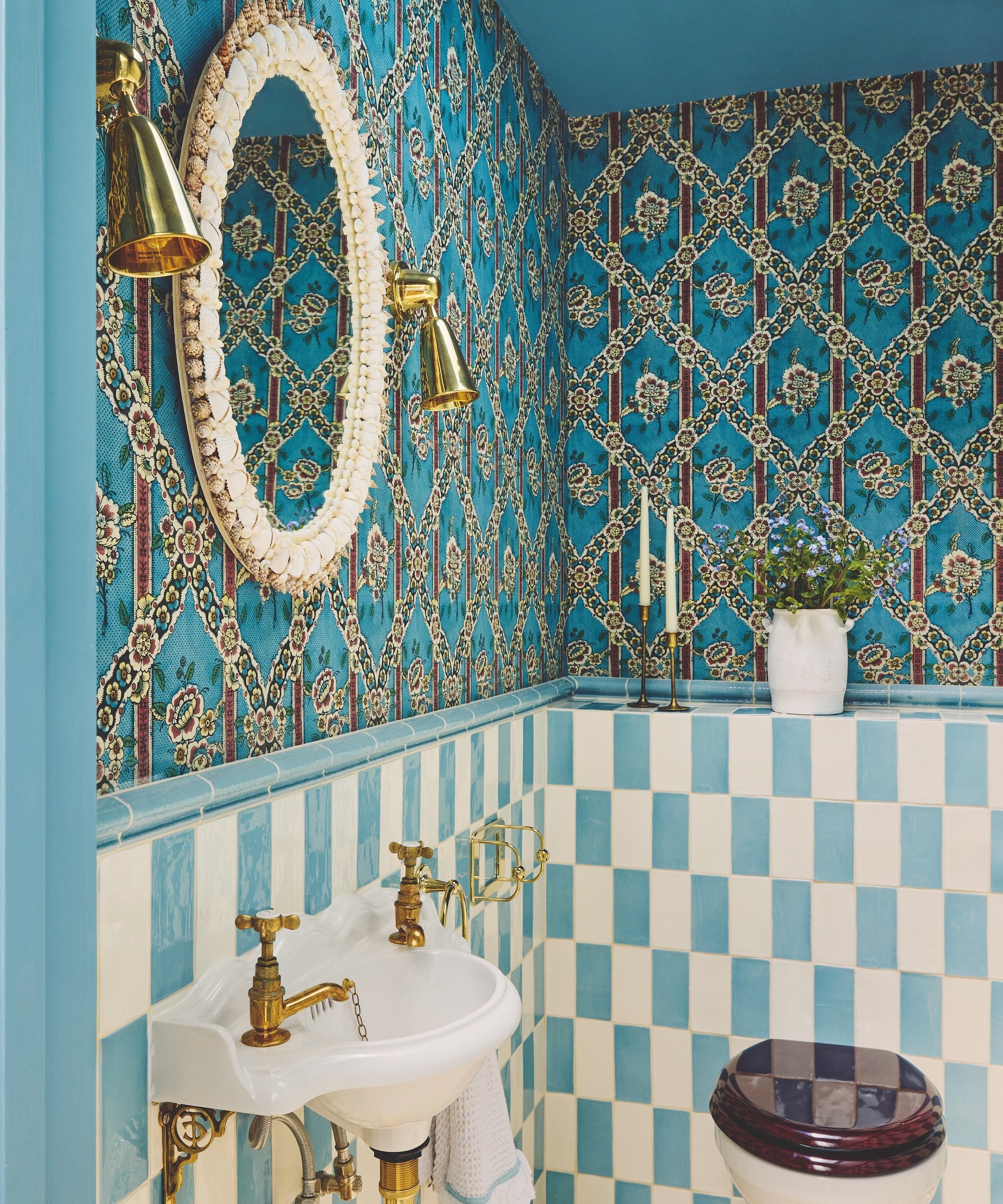 bathroom with blue patterned wallpaper and blue and white checked tiles