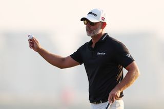 Paul Waring waves to the crowd on the 18th green