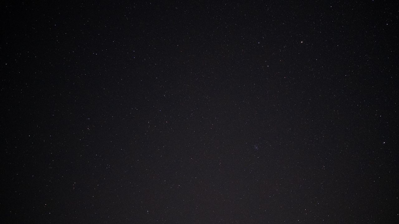 Stars in the night sky with the Beehive Cluster.
