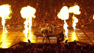 Metallica playing onstage amid giant flames in the Through The Never movie