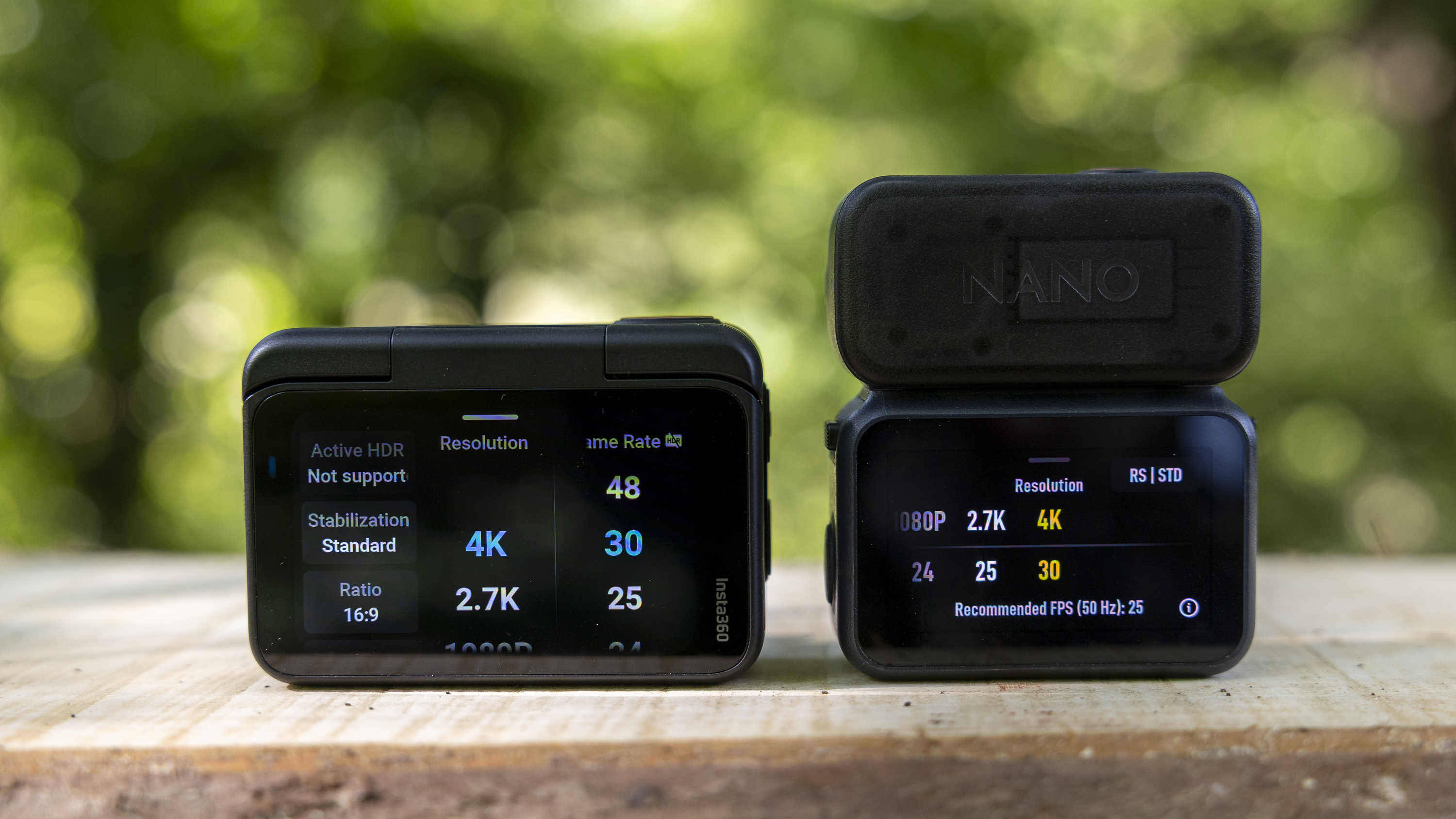 The DJI Osmo Nano and Insta360 Go Ultra next to each other on a bench in a sunny wood