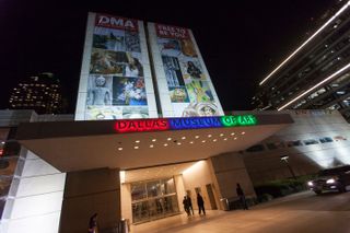 The entrance of the dallas museum of arts captured from the bottom up and photographed at night