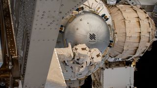 The Nanoracks Bishop airlock is pictured after its installation to the International Space Station's Tranquility module, on Dec. 20, 2020. The station's Canadarm2 robotic arm, which relocated the airlock from the trunk of SpaceX's Dragon cargo spacecraft to its new home outside Tranquility, is still attached to the airlock in this view. Adjacent to Bishop on the aft side of Tranquility is the Bigelow Expandable Activity Module, or BEAM.