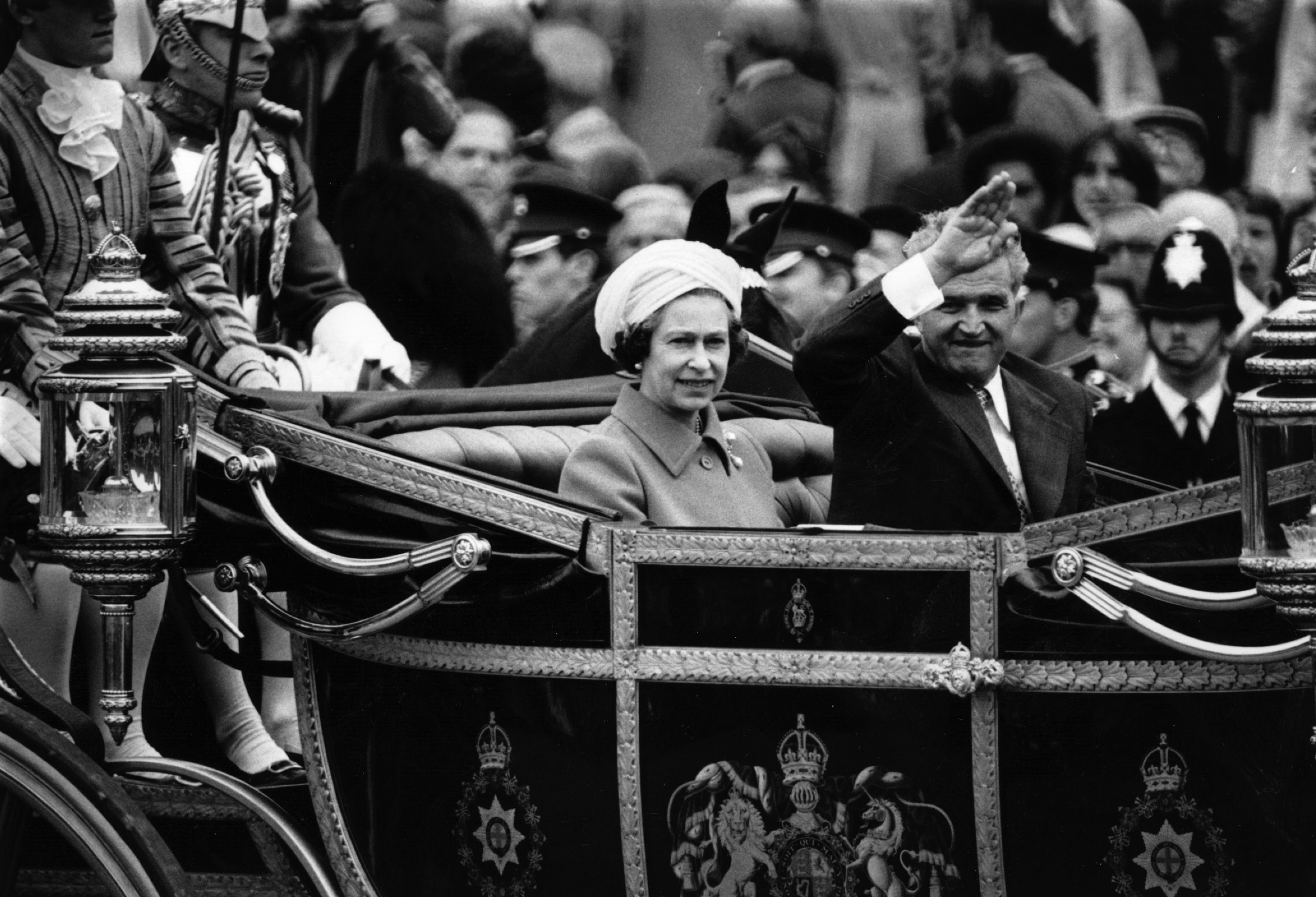 Queen Elizabeth riding in a carriage with Nicolae Ceaușescu
