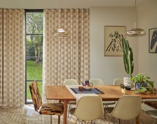 Fun beige curtains hanging in a contemporary dining room