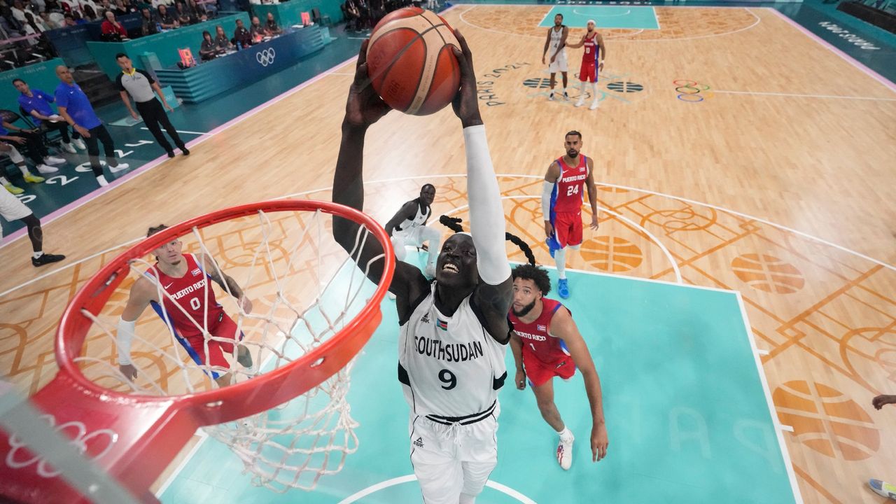 South Sudan&#039;s Wenyen Gabriel goes for a dunk in the men&#039;s preliminary round group C basketball match between South Sudan and Puerto Rico