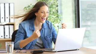 Woman with a laptop at office and the hair moved by the wind