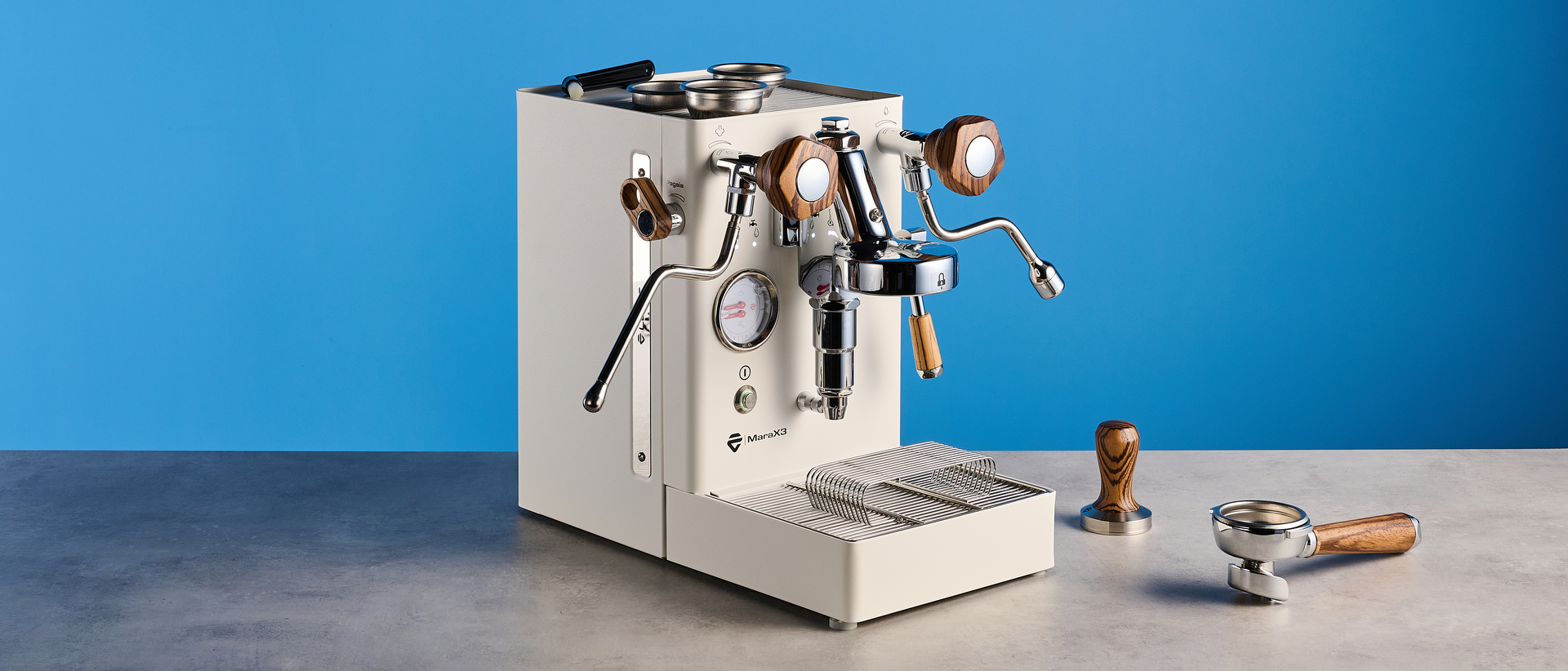 the lelit mara x3 in white and walnut photographed against a blue tom's guide background