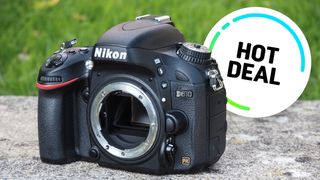 Nikon D610 body on garden wall with Hot Deal sticker over image