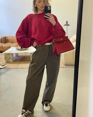 Elsa Hosk wearing a sweatshirt, trousers, and sneakers.