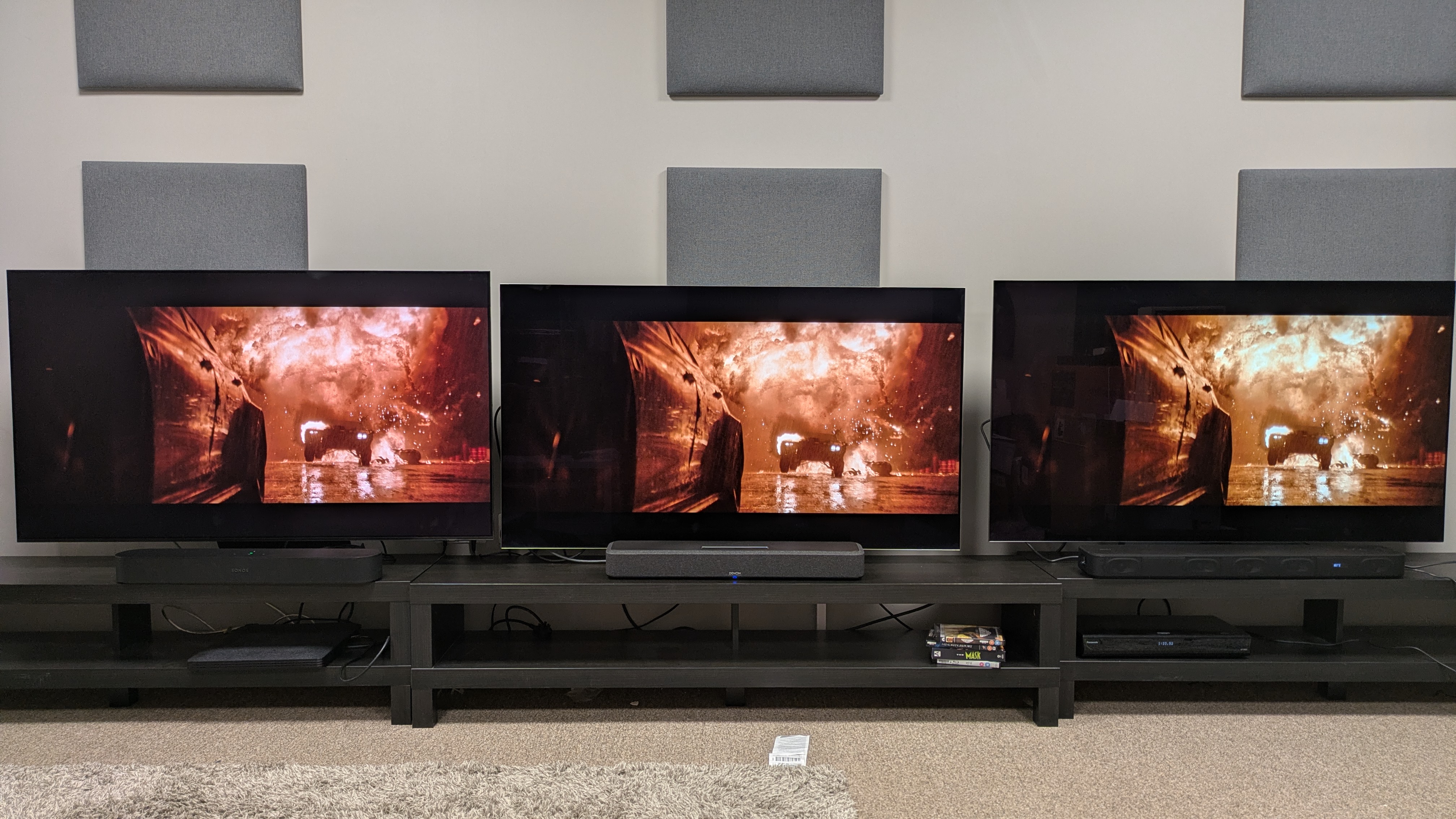 Sonos Beam (Gen 2) (left) under Samsung S95F , Denon Home 550 (middle) under LG G5 and Sony HT-S2000 (right) under LG C5, all showing the Batmobile coming through an explosion from The Batman
