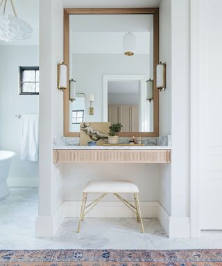 White bathroom with vanity area and table