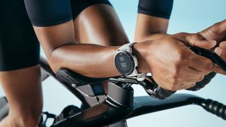 Wahoo Elemnt Rival Review: person riding a tri bike wearing the watch