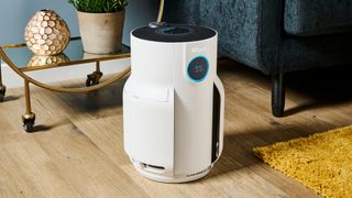 A white Shark NeverChange air purifier pictured in a living room environment.