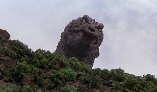 Godzilla, Mothra, King Ghidorah: Giant Monsters All-Out Attack Godzilla peers over a hill, sneering