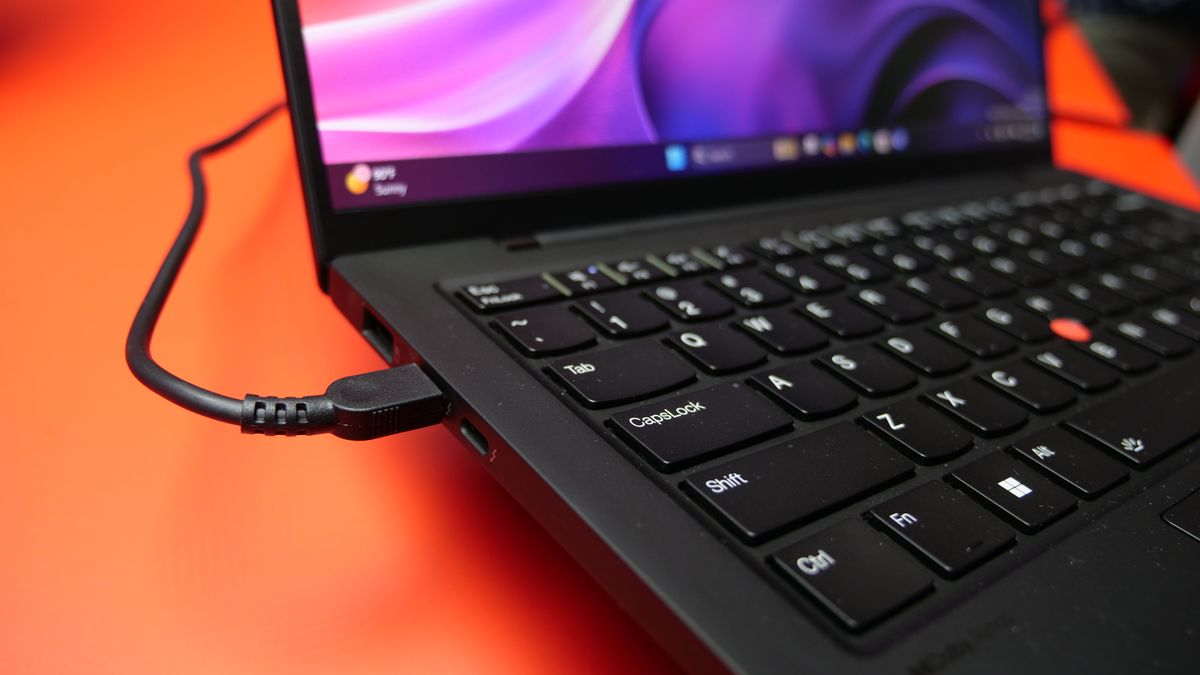 Images of the Lenovo ThinkPad X1 Carbon Gen 13 Aura Edition on a red table at IFA 2024