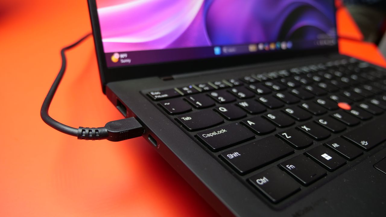 Images of the Lenovo ThinkPad X1 Carbon Gen 13 Aura Edition on a red table at IFA 2024