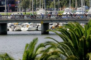 The peloton, estimated to be around 5,000 strong, roll across a bridge near Glenelg in South Australia.