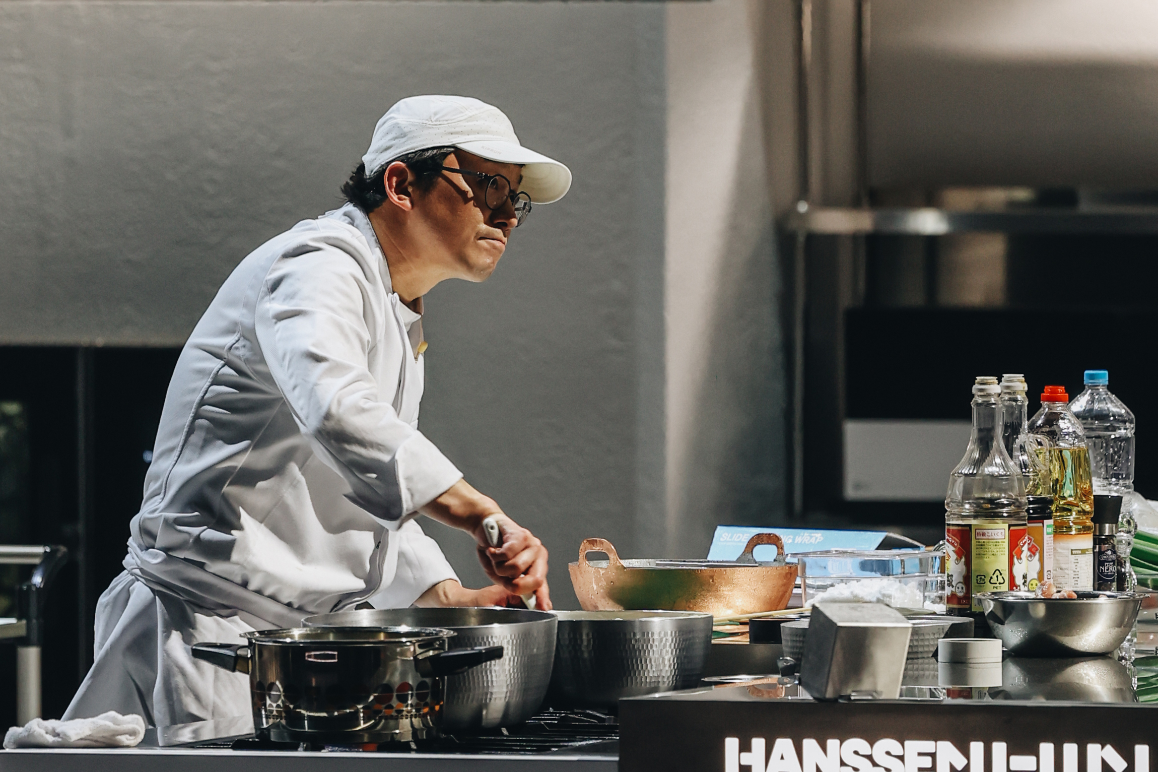Chef Choi Kang-rok stirs a pot at a cook station in the 'Culinary Class Wars' season 2 finale.