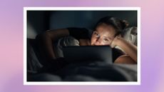 woman watching a tablet in the dark in bed