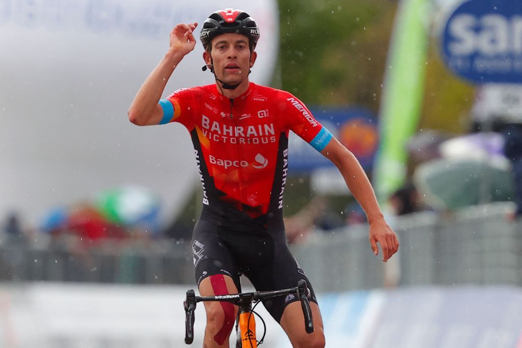 TOPSHOT Team Bahrain rider Switzerlands Gino Mader celebrates as he crosses the finish line to win during the sixth stage of the Giro dItalia 2021 cycling race 160 km between Grotte di Frasassi and Ascoli Piceno San Giacomo on May 13 2021 Photo by Luca Bettini AFP Photo by LUCA BETTINIAFP via Getty Images