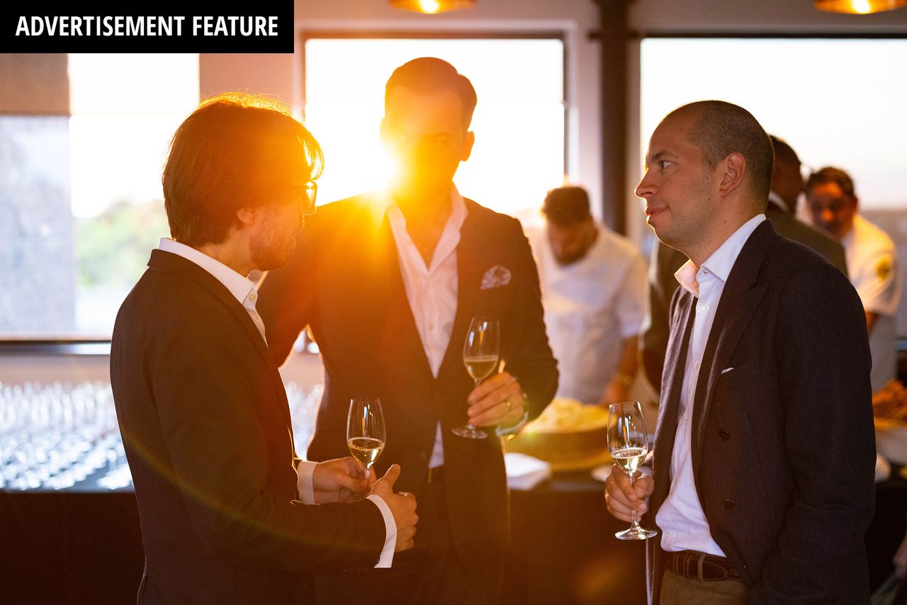 Businessmen drinking wine