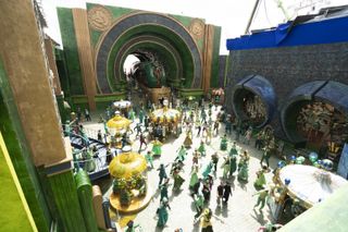 A crowd films on a massive Emerald City set for 'Wicked.'