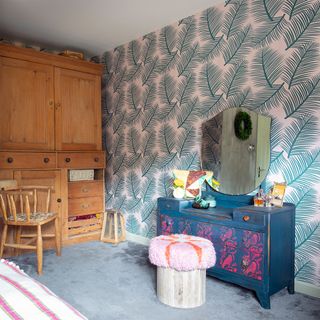 colourful bedroom with wallpaper and dressing table