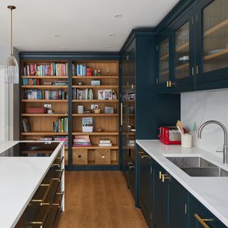 dark green kitchen with wood open shelving