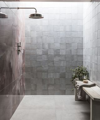 White shower room with square tiles and wood bench