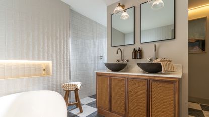 A bathroom with wooden cabinets and dual sinks