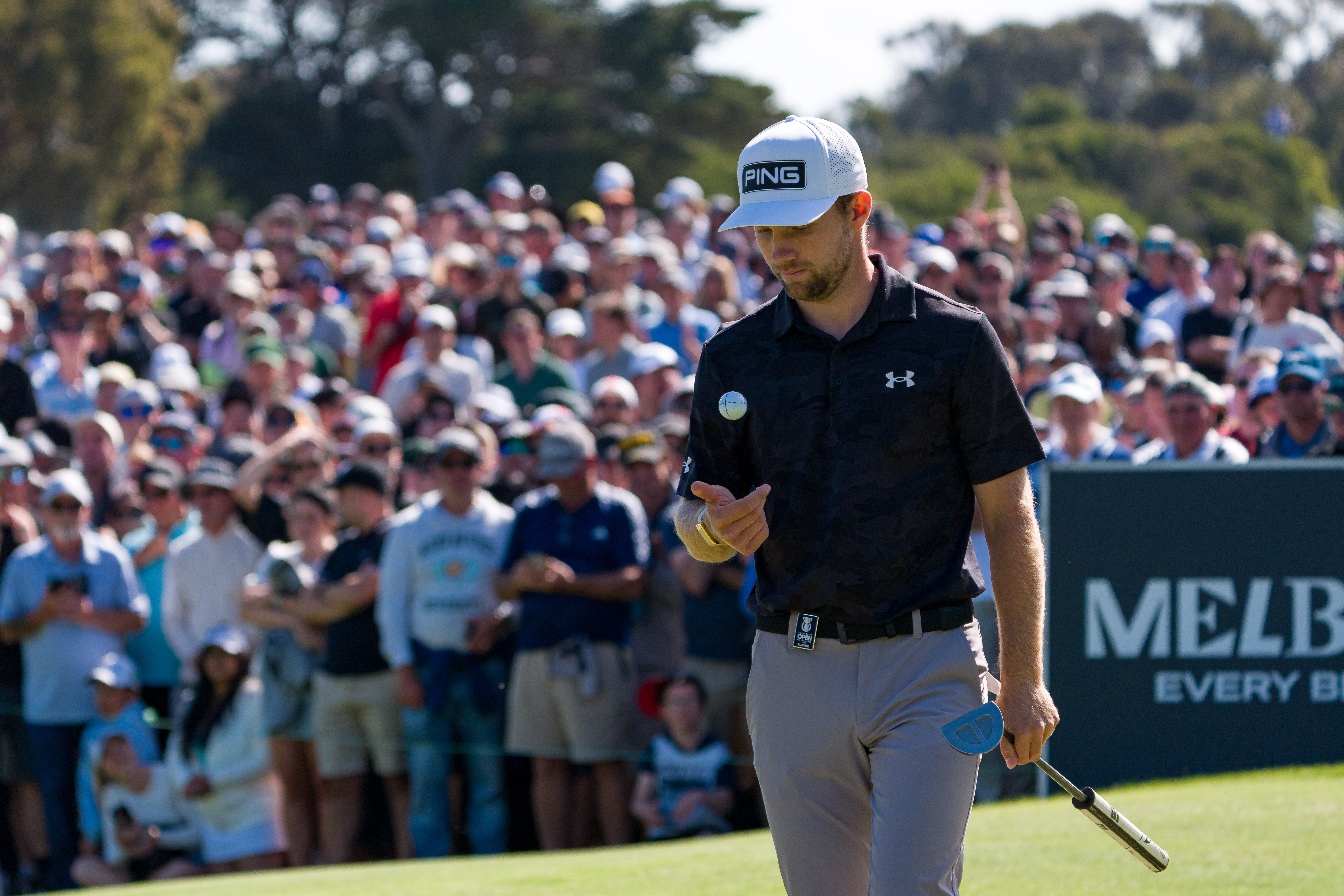 Rasmus Neergaard-Petersen throws a golf ball in the air and catches it