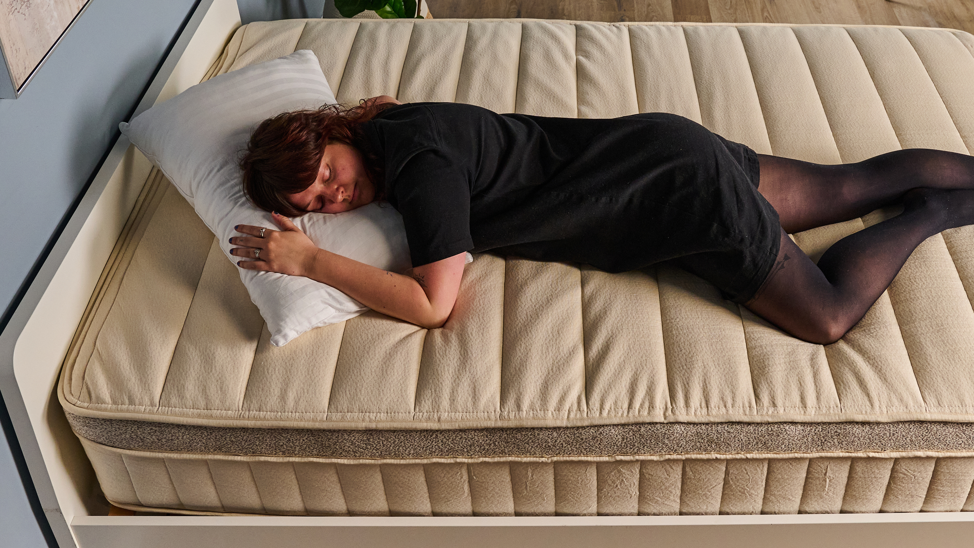 A Tom's Guide tester sleeping on her front on the Birch Luxe Natural mattress