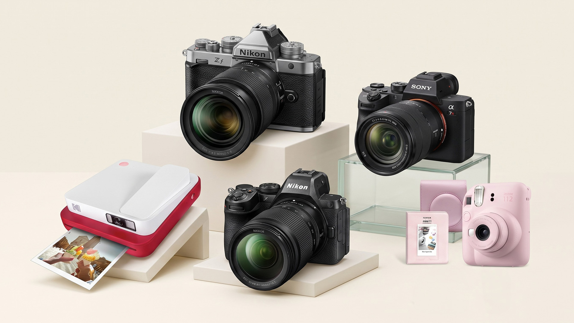 A selection of cameras on a cream background.