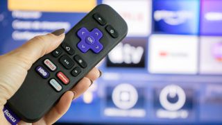 Roku remote in front of TV 