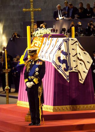 The then-Prince Charles standing guard over the coffin of the Queen Mother