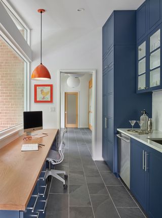 A home office with kitchen painted blue