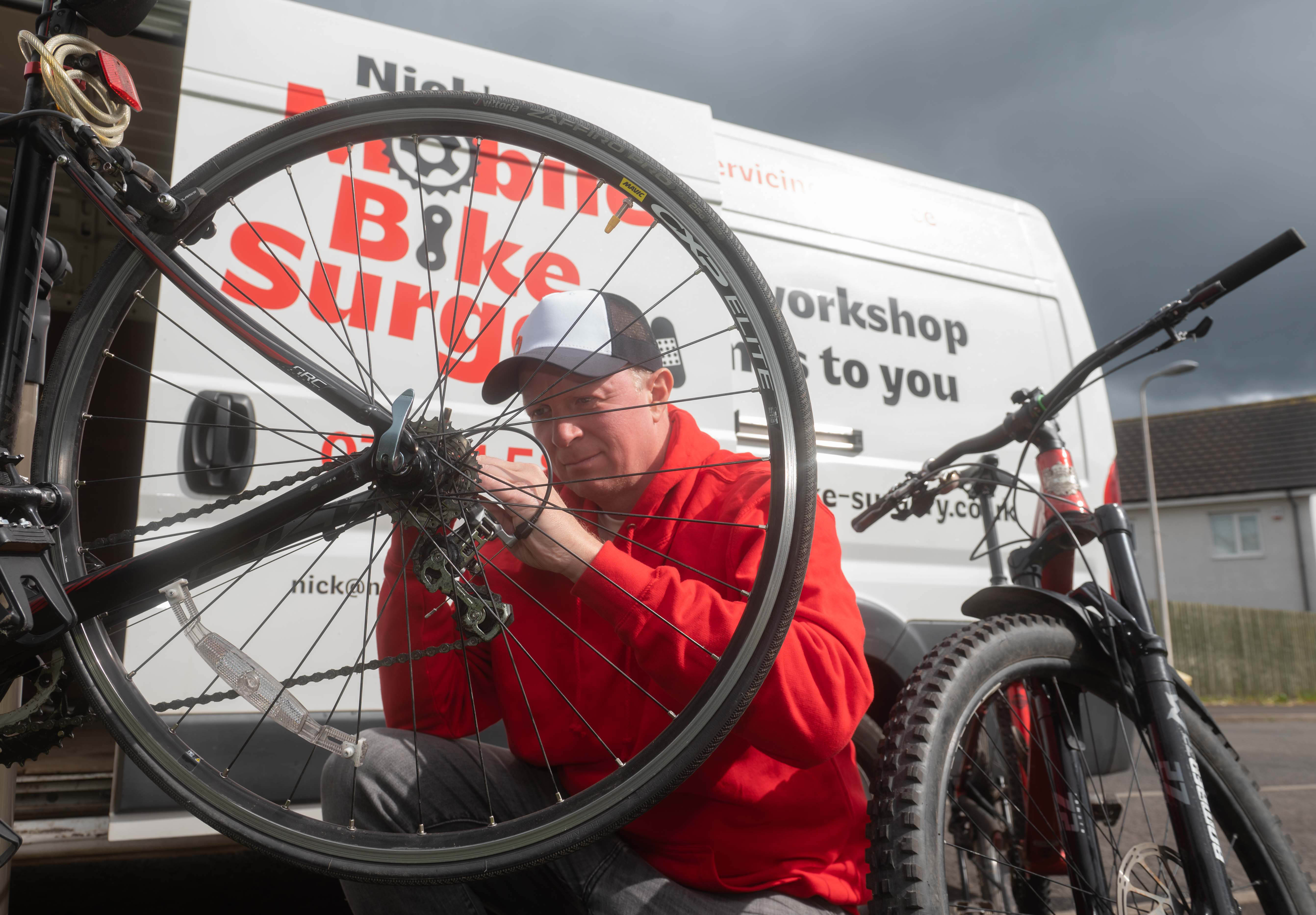 Mobile mechanic Nick Sharpe working on a road bike